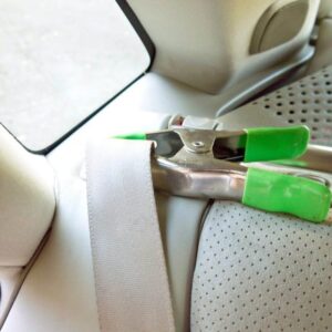 Use a clamp to prevent the belt from retracting as you clean