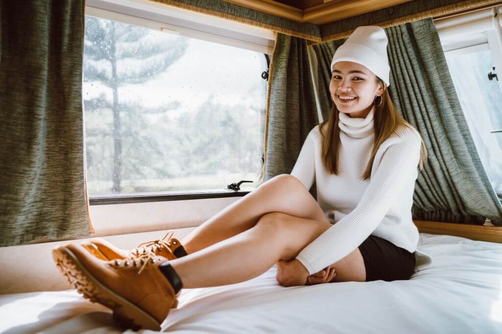 Young girl is sitting on the bed in the rv